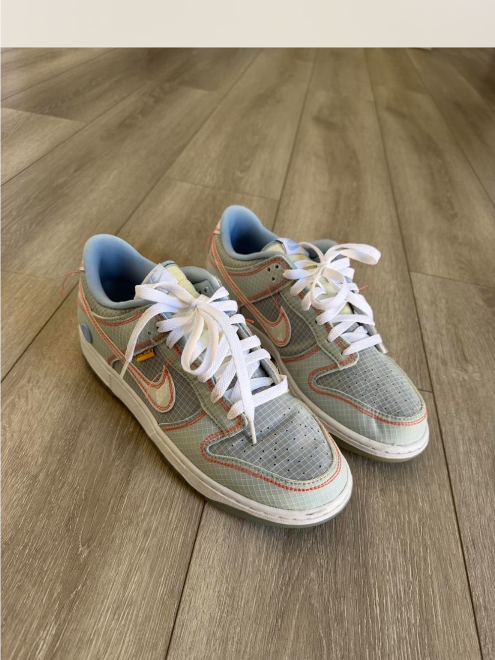 Nike Men’s Low Dunks in Light Gray, Blue, and Orange Trim